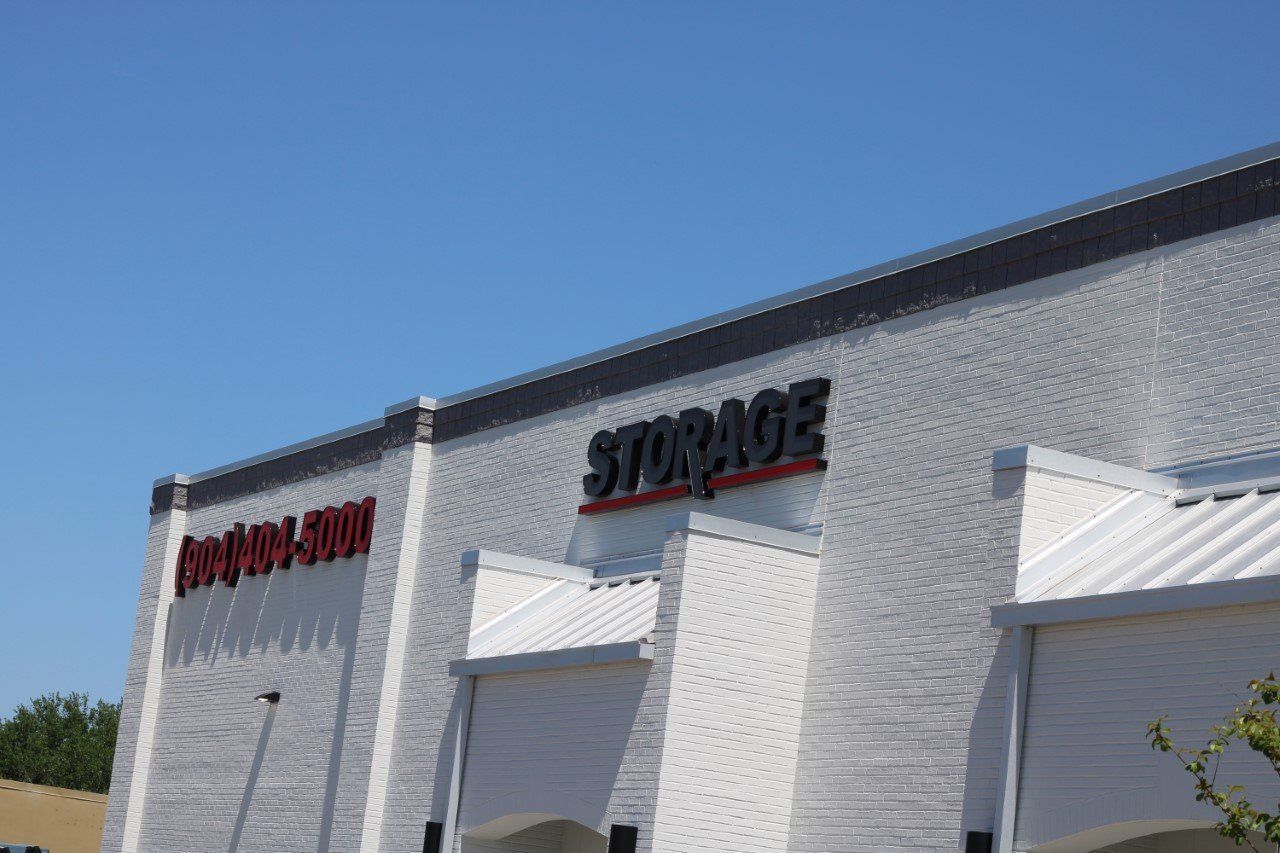 Storage facility exterior with white facade, black 