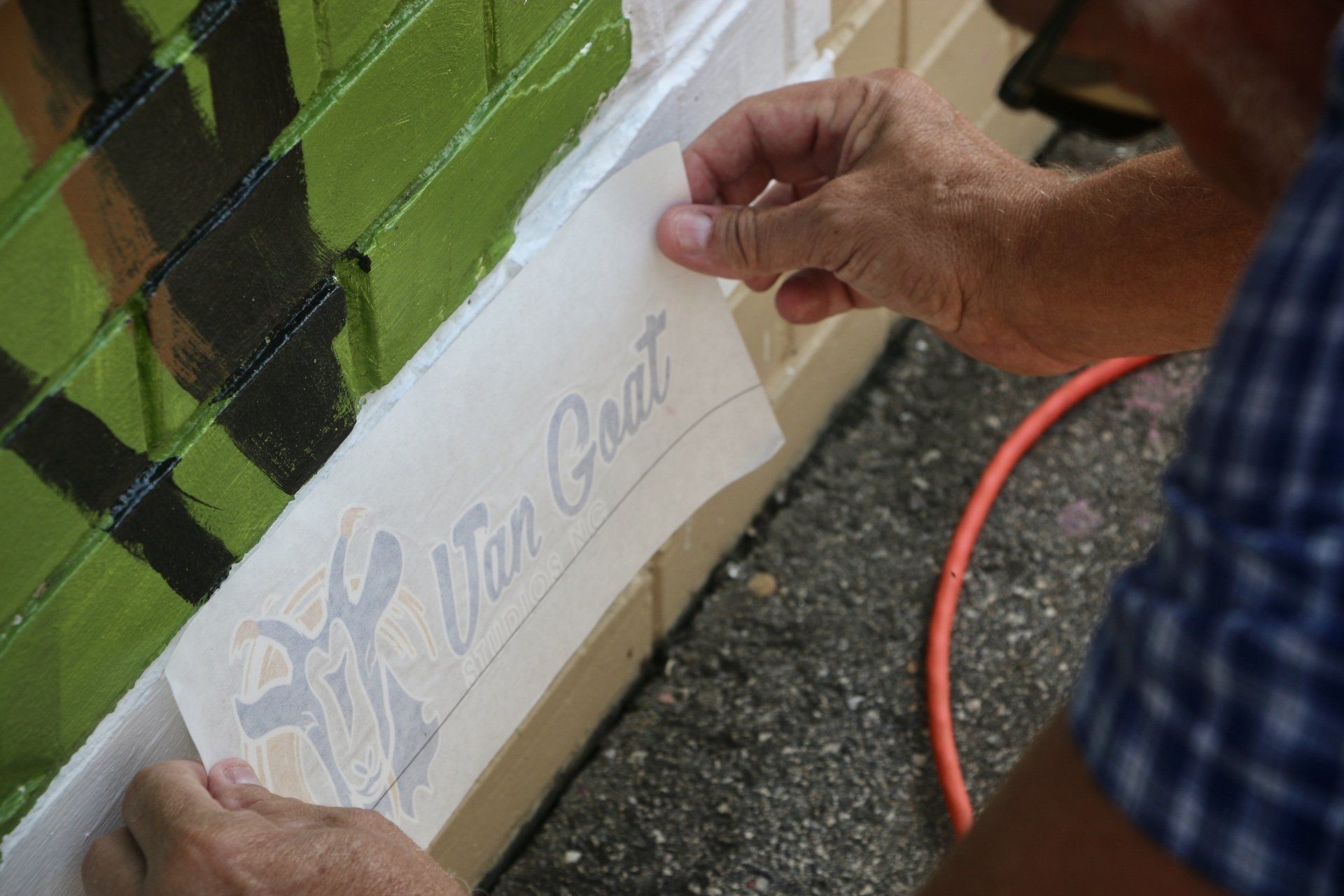 Picture of the Van Goat Sticker being placed on a new mural in Angier, North Carolina