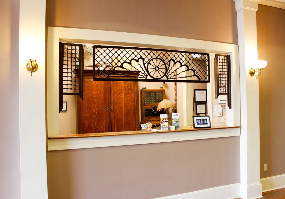 A hotel lobby with a large window and a counter.