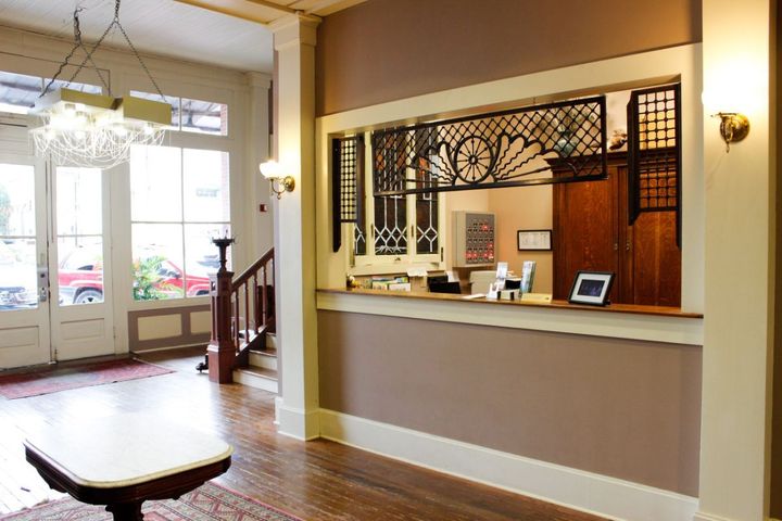 A hotel lobby with a counter and a table