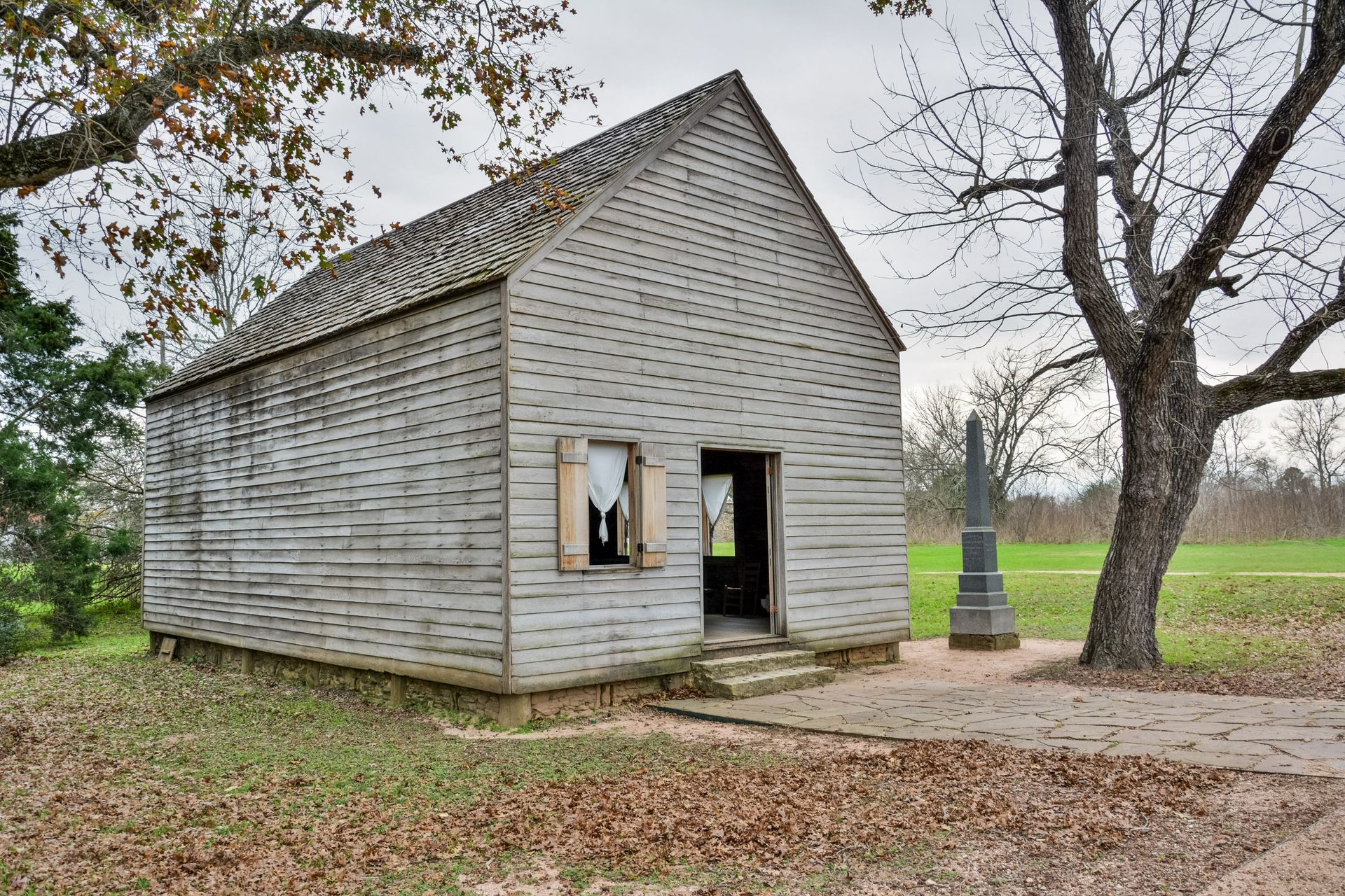 A band performs on a stage lit with purple lights in an ornate theater.