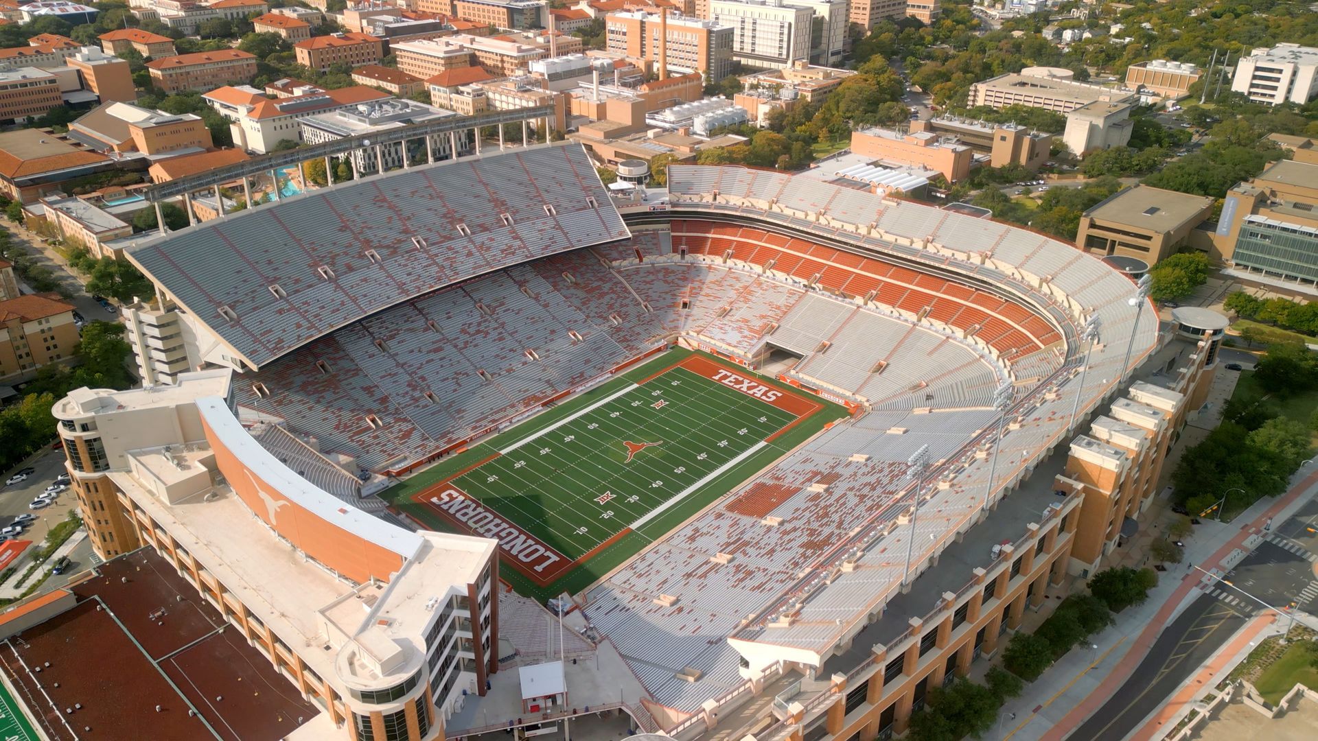 A large auditorium filled with rows of red seats and a stage.