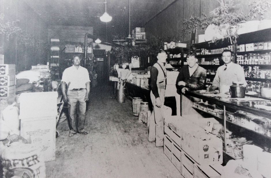 A black and white photo of a store with a sign that says after