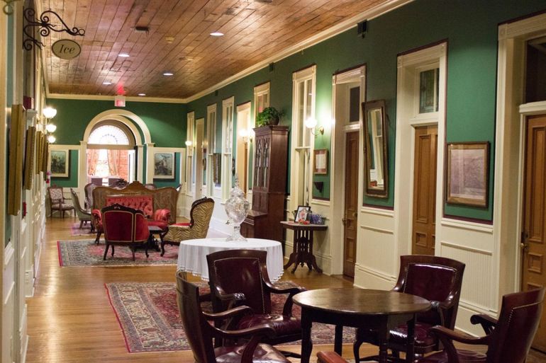 A long hallway with tables and chairs in it