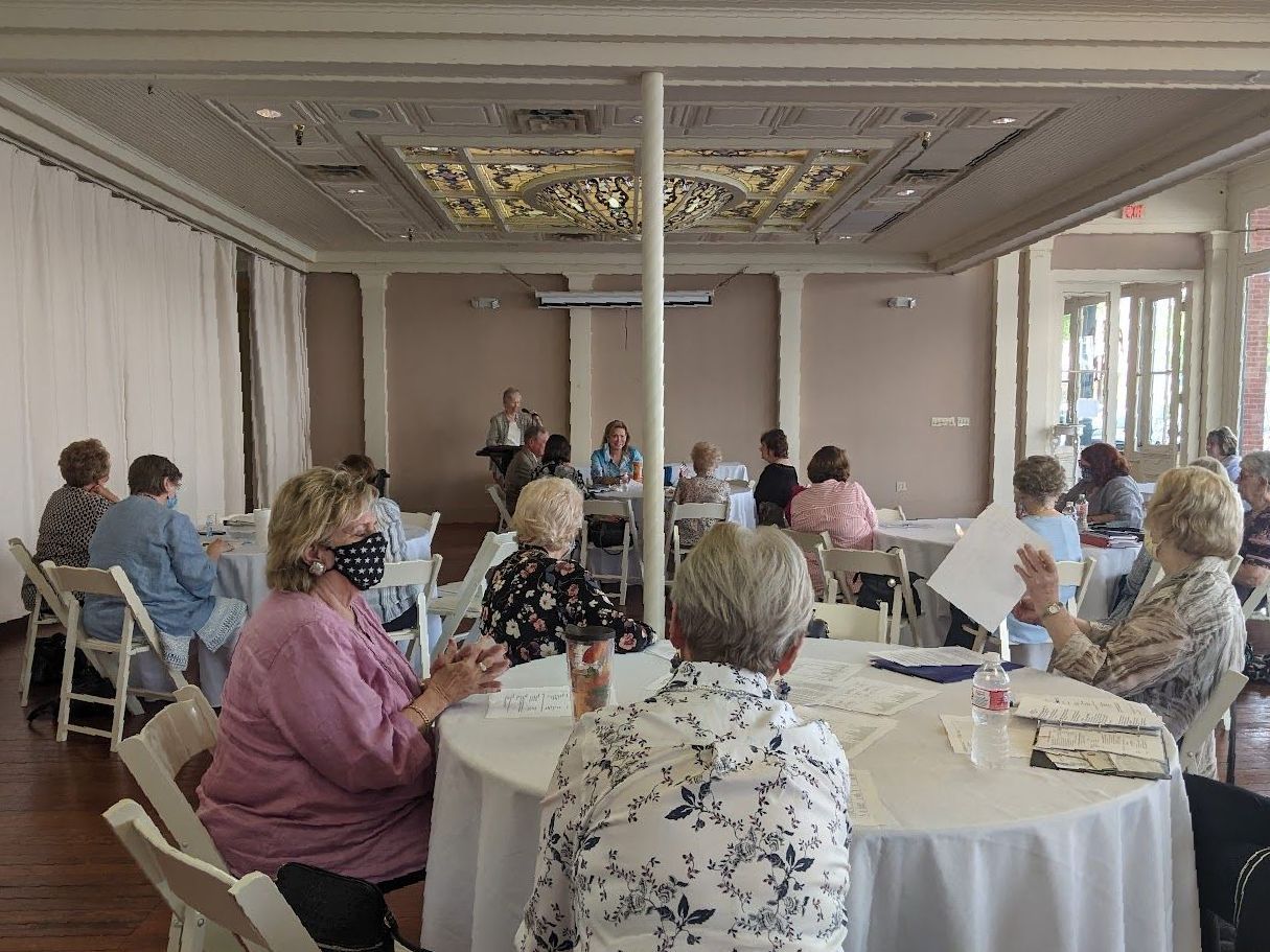 A group of people are sitting at tables in a room.