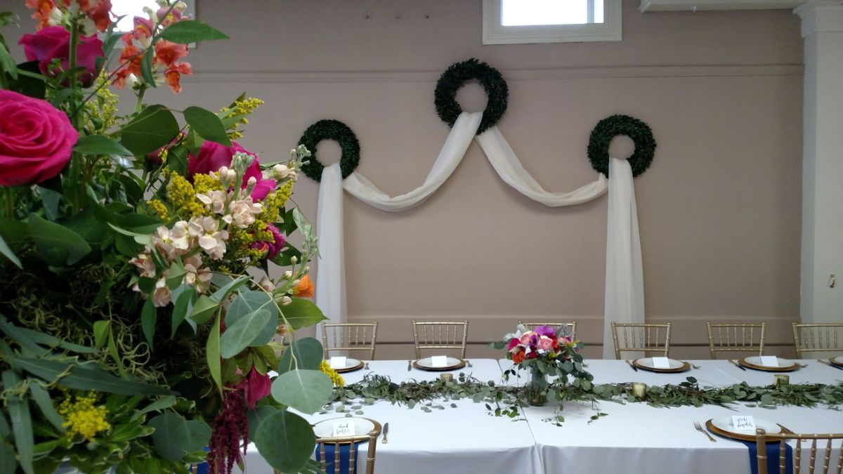 A table with plates and flowers on it in a room.