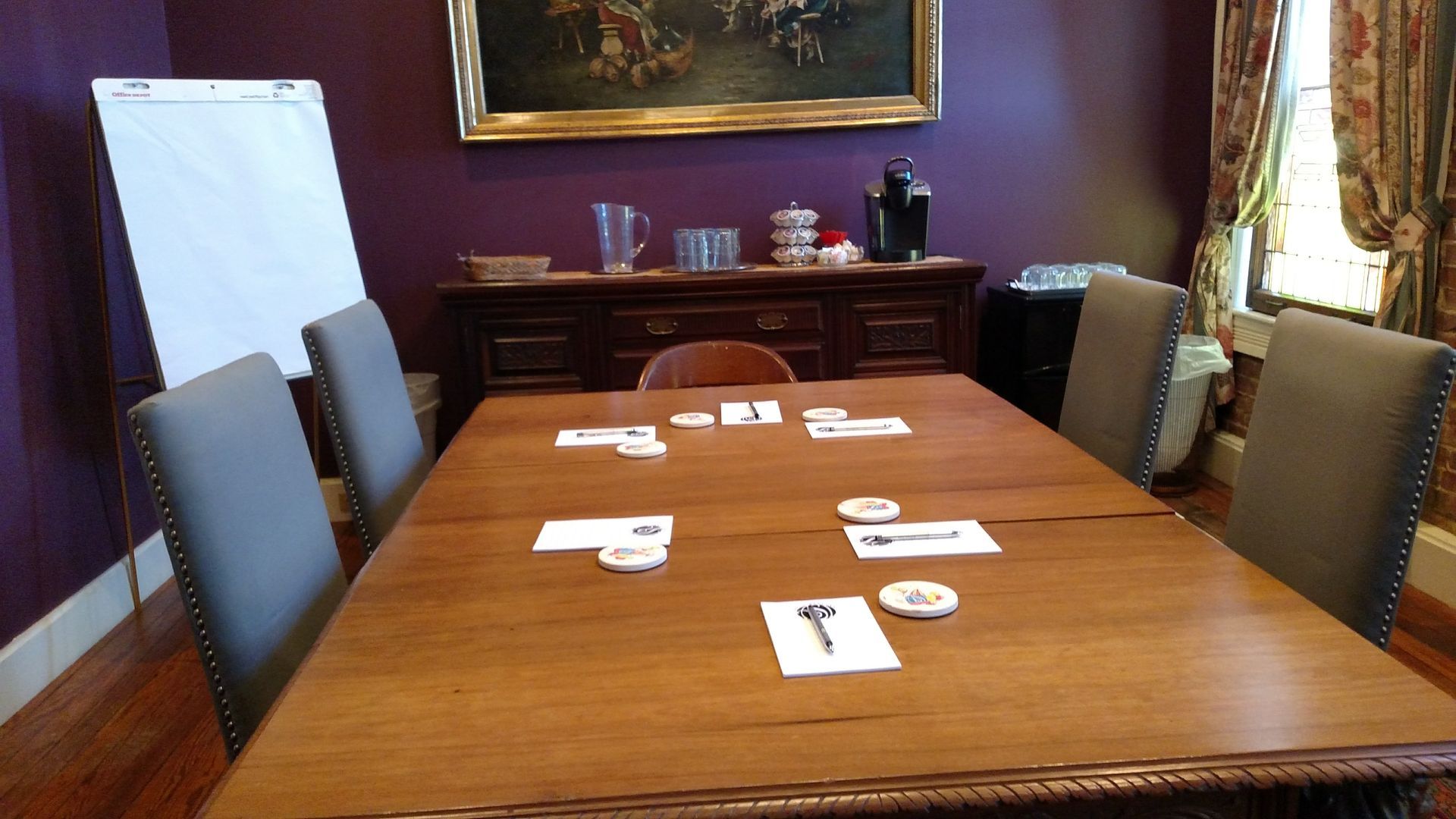 A conference room with a long wooden table and chairs