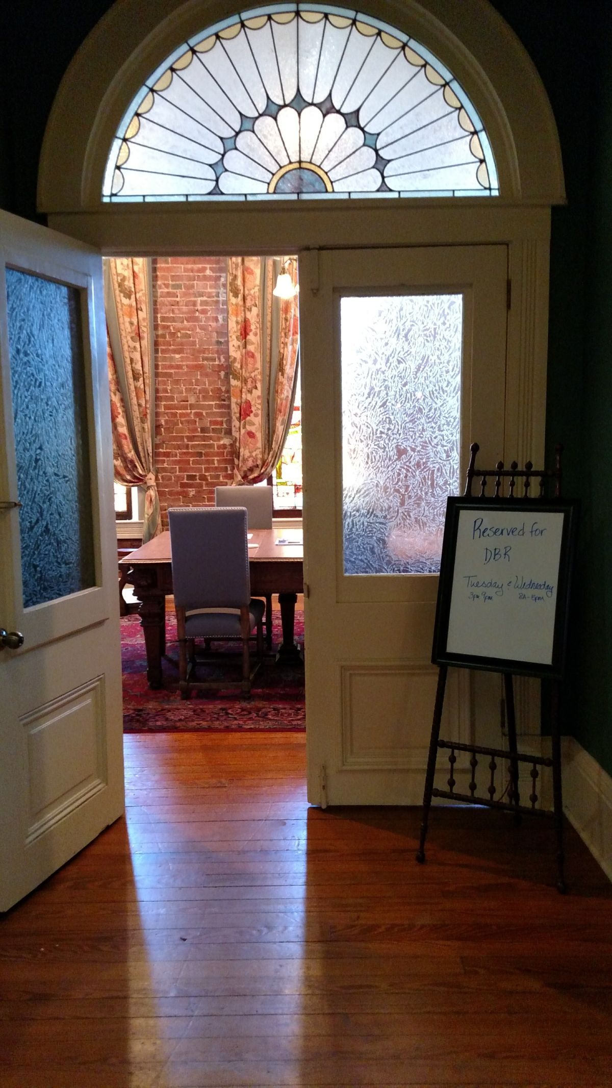 A doorway leading to a dining room with a table and chairs.