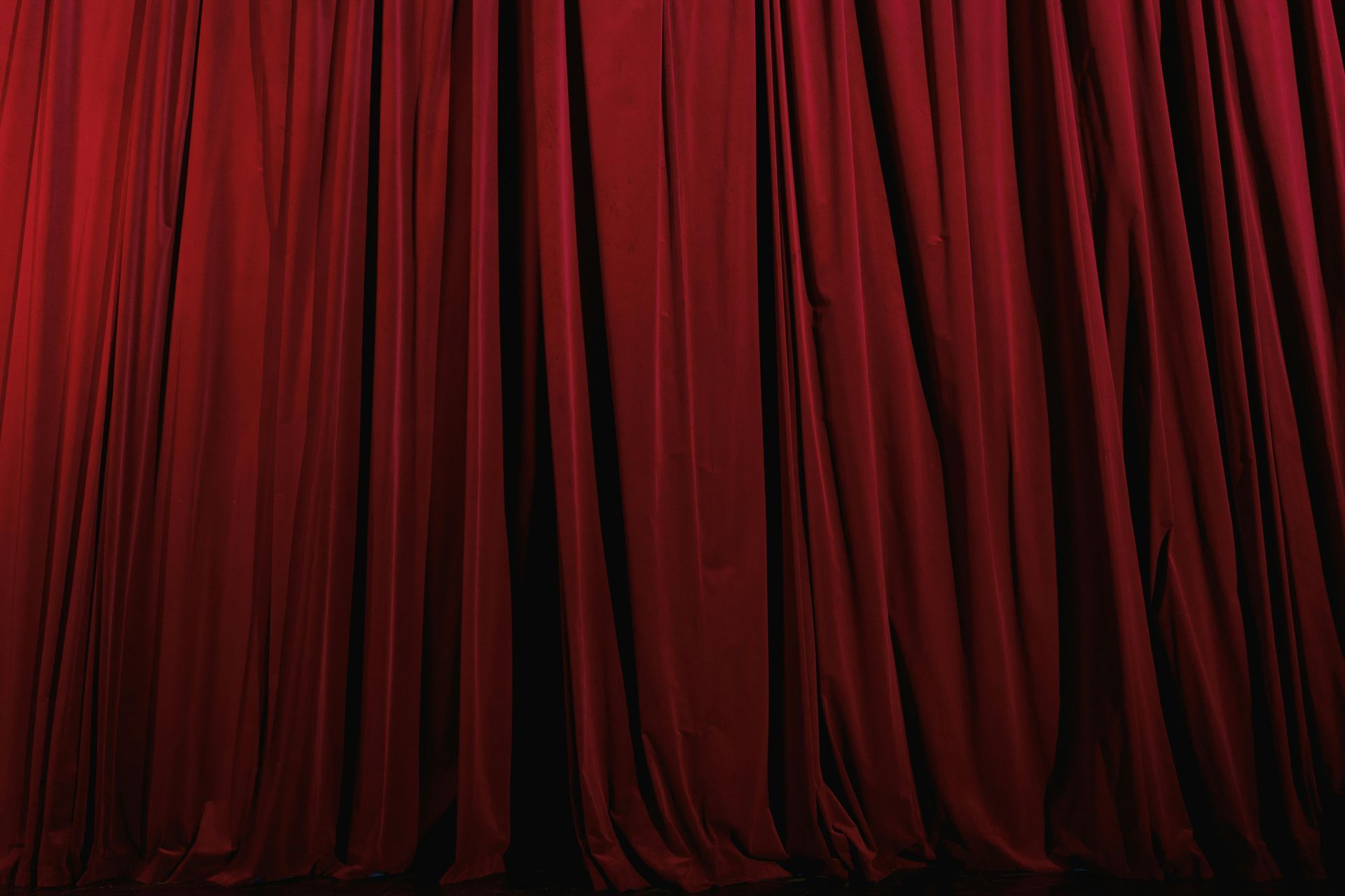 A close up of a red curtain on a stage.