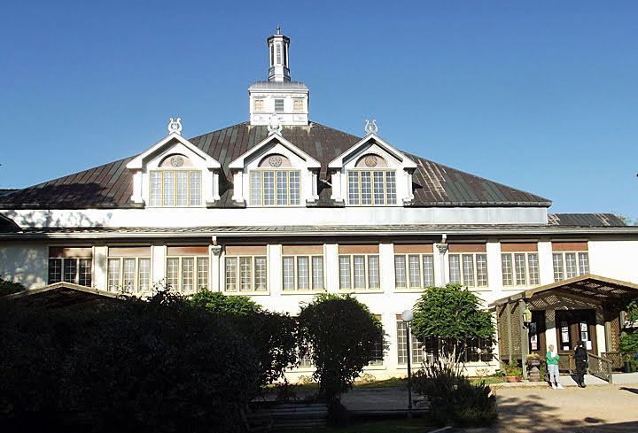 An image of Round Top Festival Institute, which is a large white building with a tower on top of it