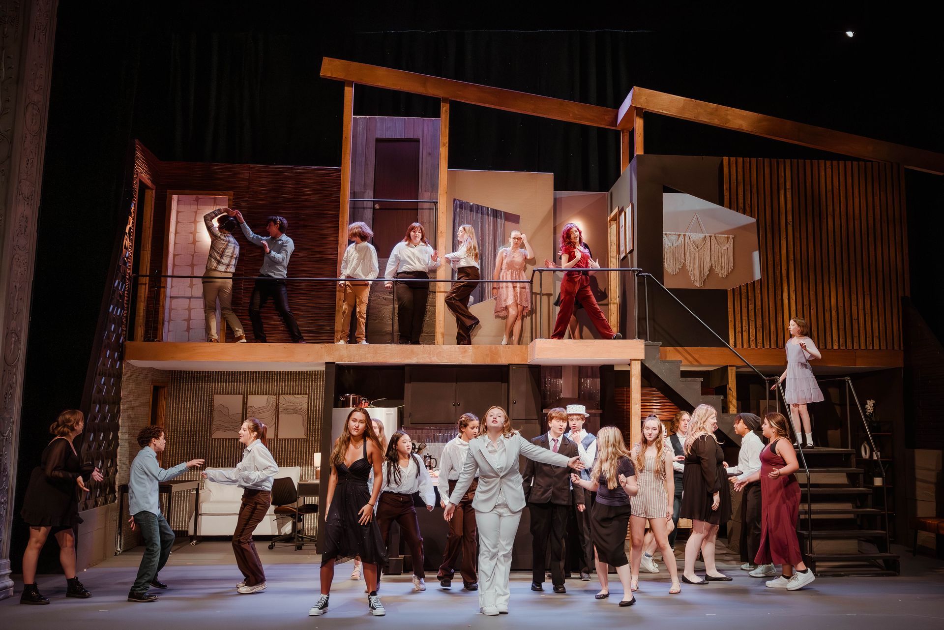 A group of young people are dancing on a stage.