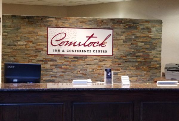 A reception desk with a sign that says comstock inn & conference center