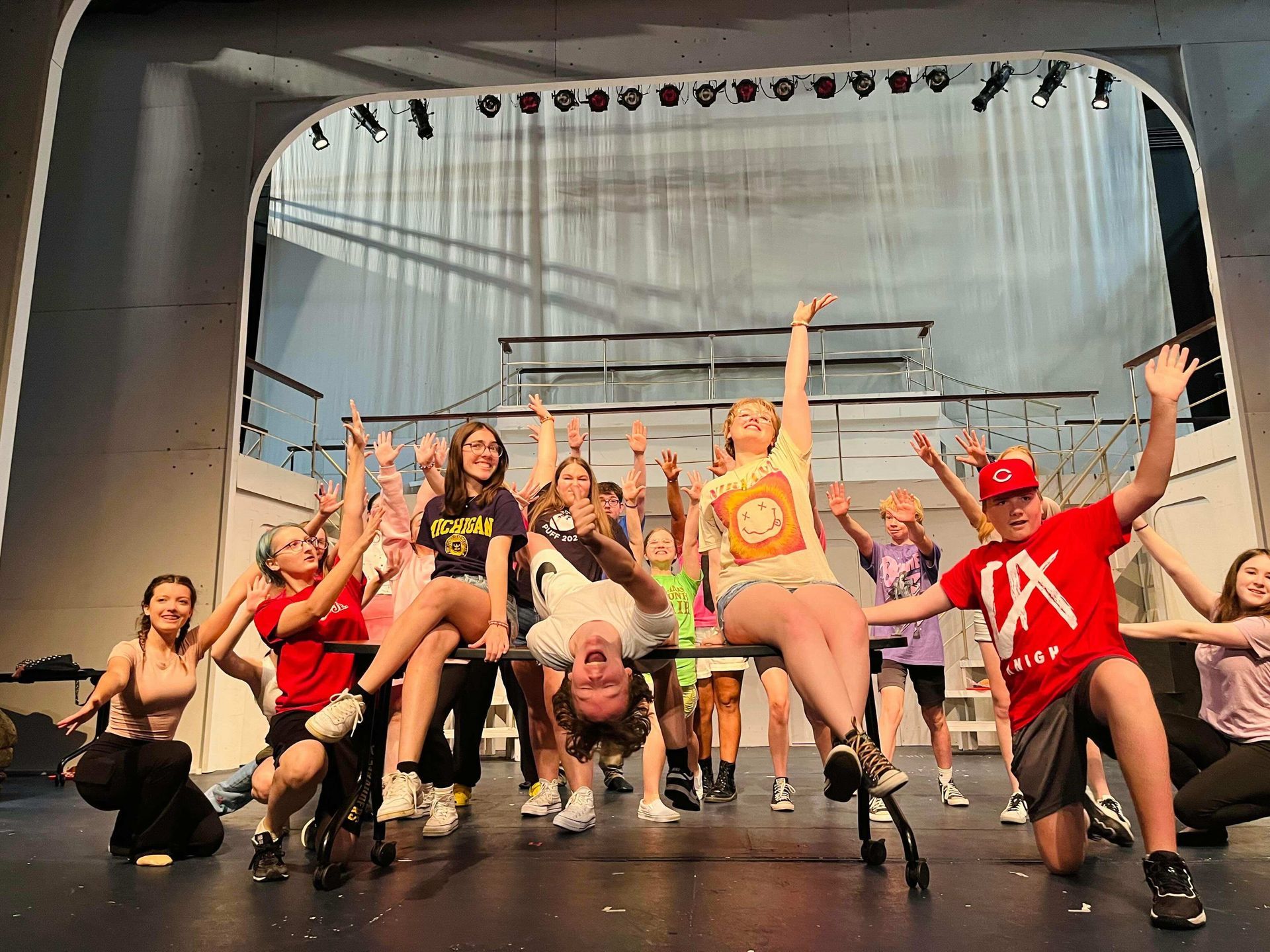 A group of young people are dancing on a stage.