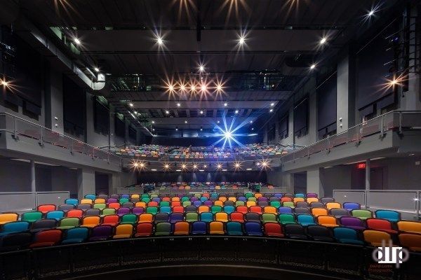 A large auditorium with a lot of colorful seats inside the Lebowsky Center.