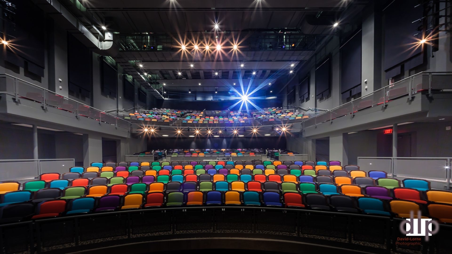 A large auditorium with a lot of colorful seats