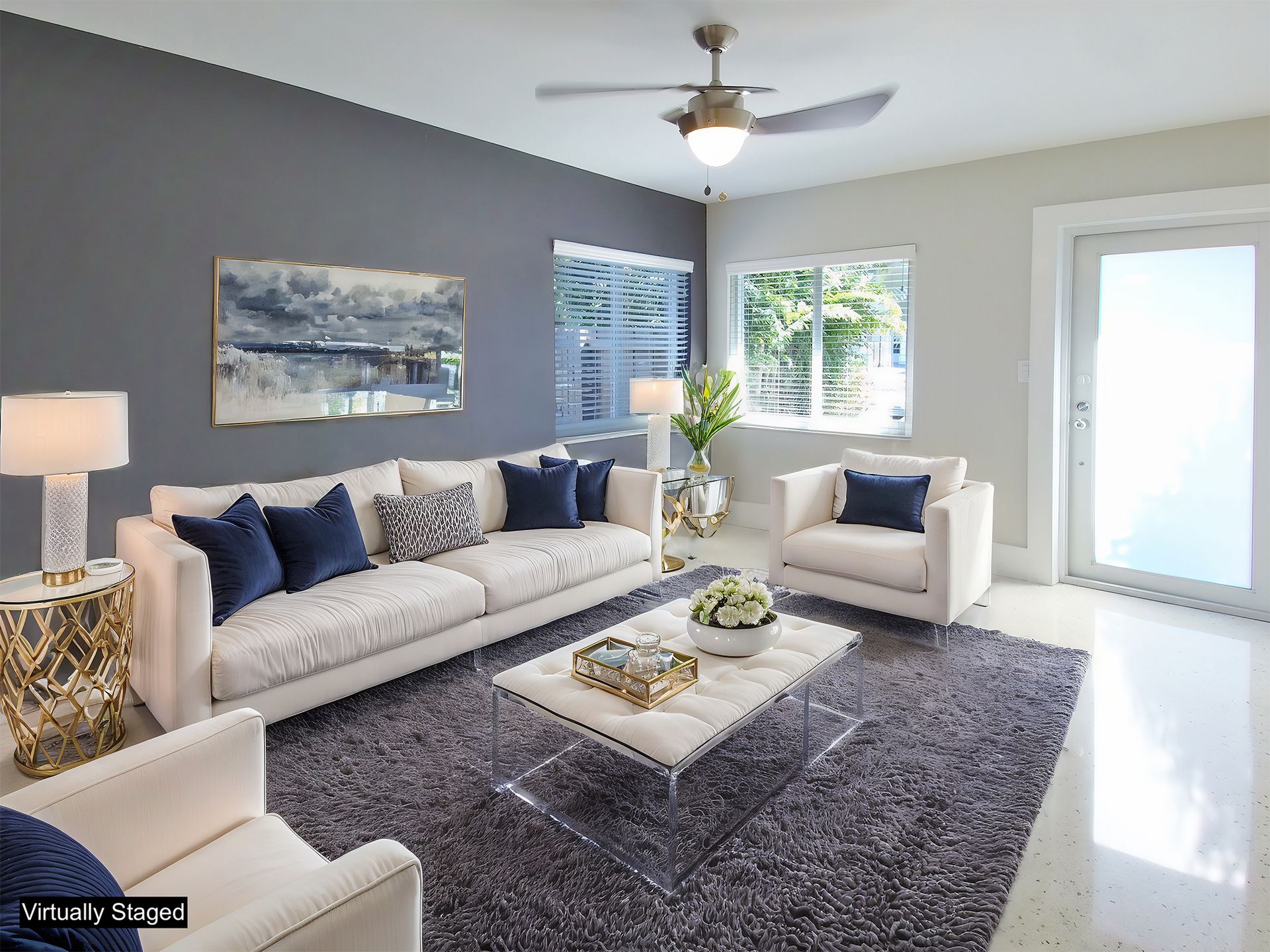 A dining room with a table and chairs and a wooden staircase.