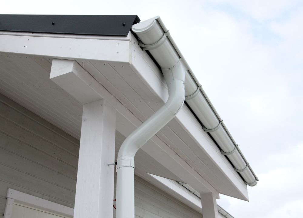 White Gutter and Downspout on a Building's White Trim — GCX Roofing In Carrara, QLD