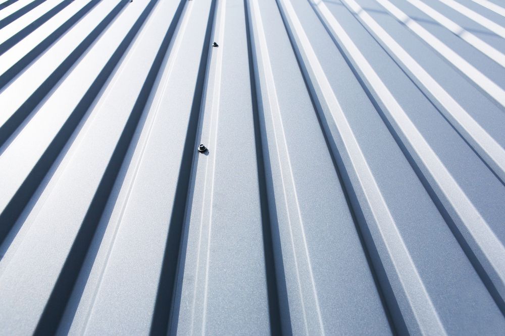 Corrugated Metal Roof, Silvery-grey, Angled View, Showing Ridged Pattern and Fasteners — GCX Roofing In Yatala, QLD