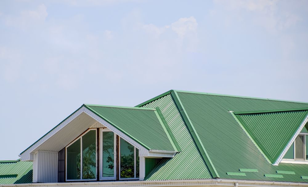 Green Metal Roof With Dormer and Triangular Windows — GCX Roofing In Ashmore, QLD