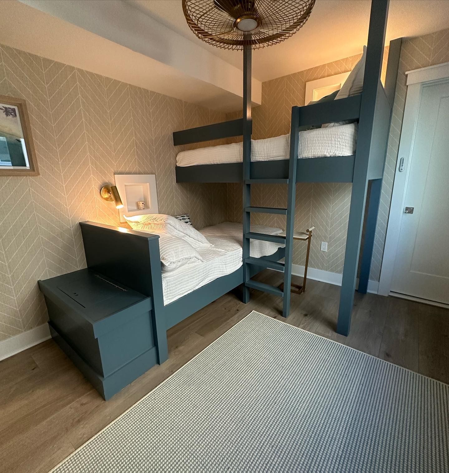 new built bunk beds in a bedroom with patterned wallpaper, a rug, and a white door in avalon, new jersey built by j.k. construction llc