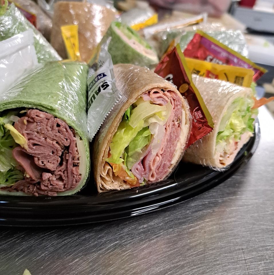 A close up of a plate of sandwiches on a table.