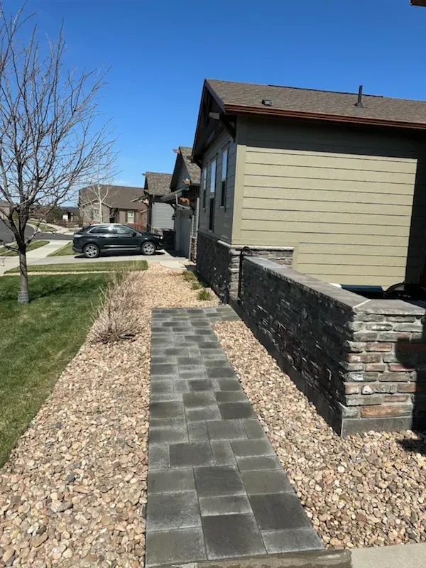 A walkway leading to a house in a residential area