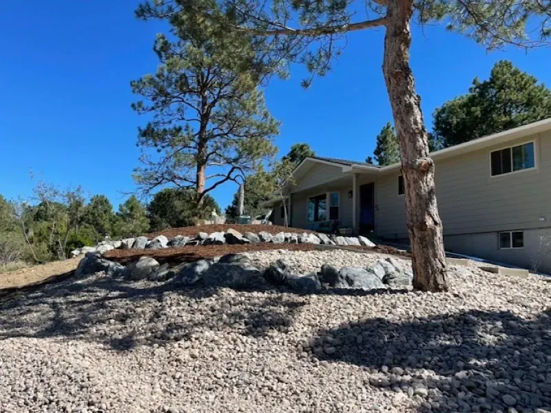 A house with a lot of rocks in front of it