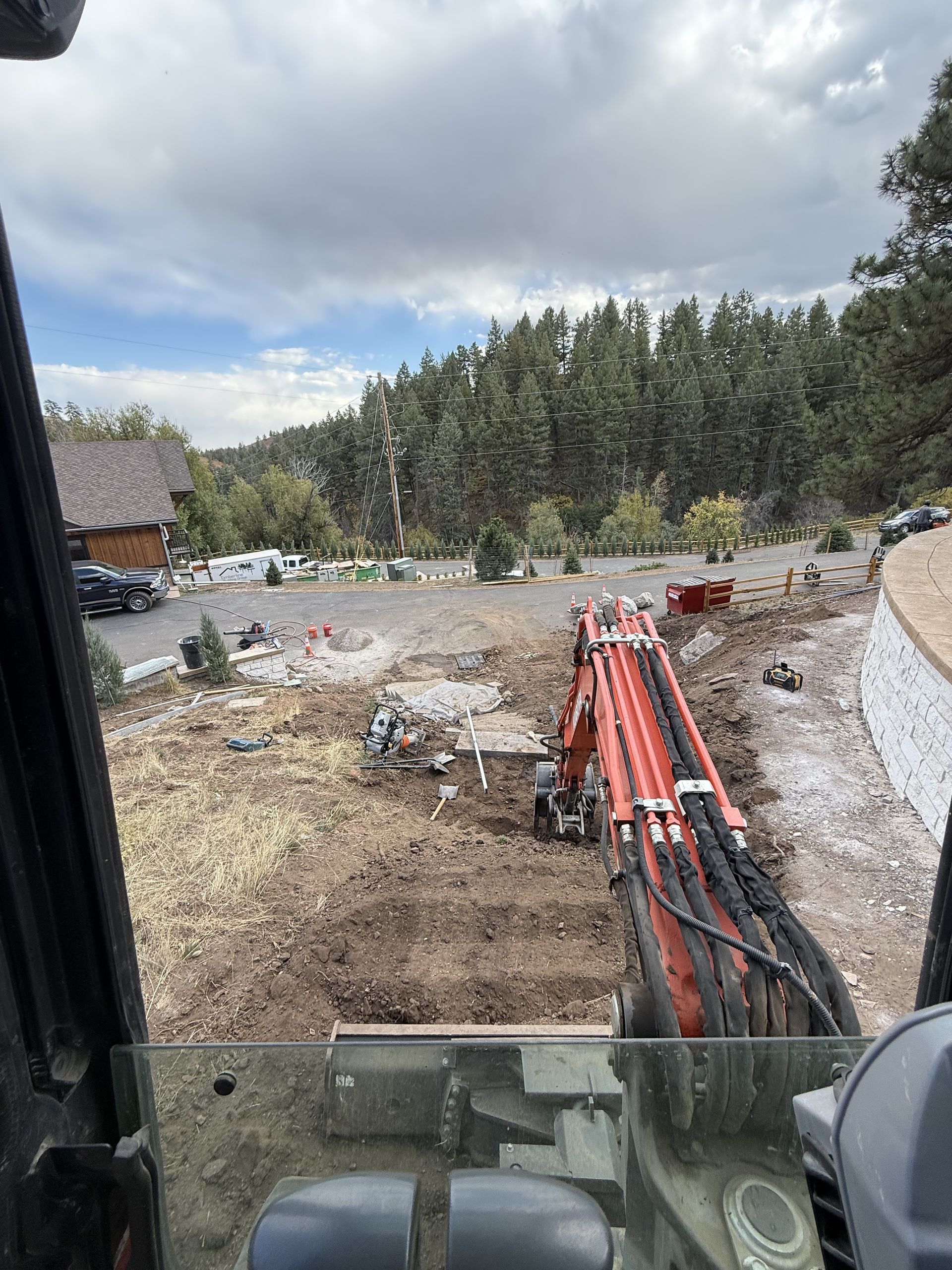 A person is driving a bulldozer on a dirt road.
