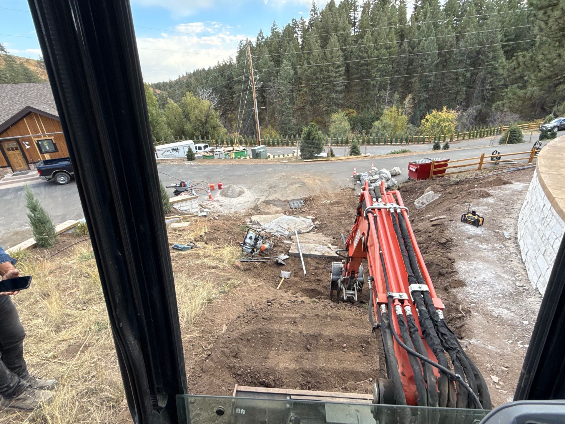 A man is looking out of a window at a construction site.