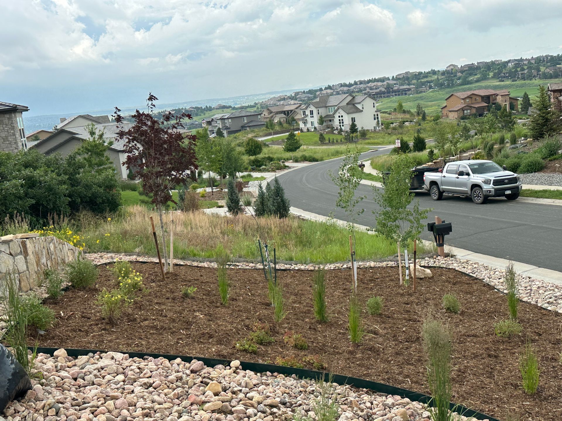 A white truck is parked on the side of the road in a residential area.