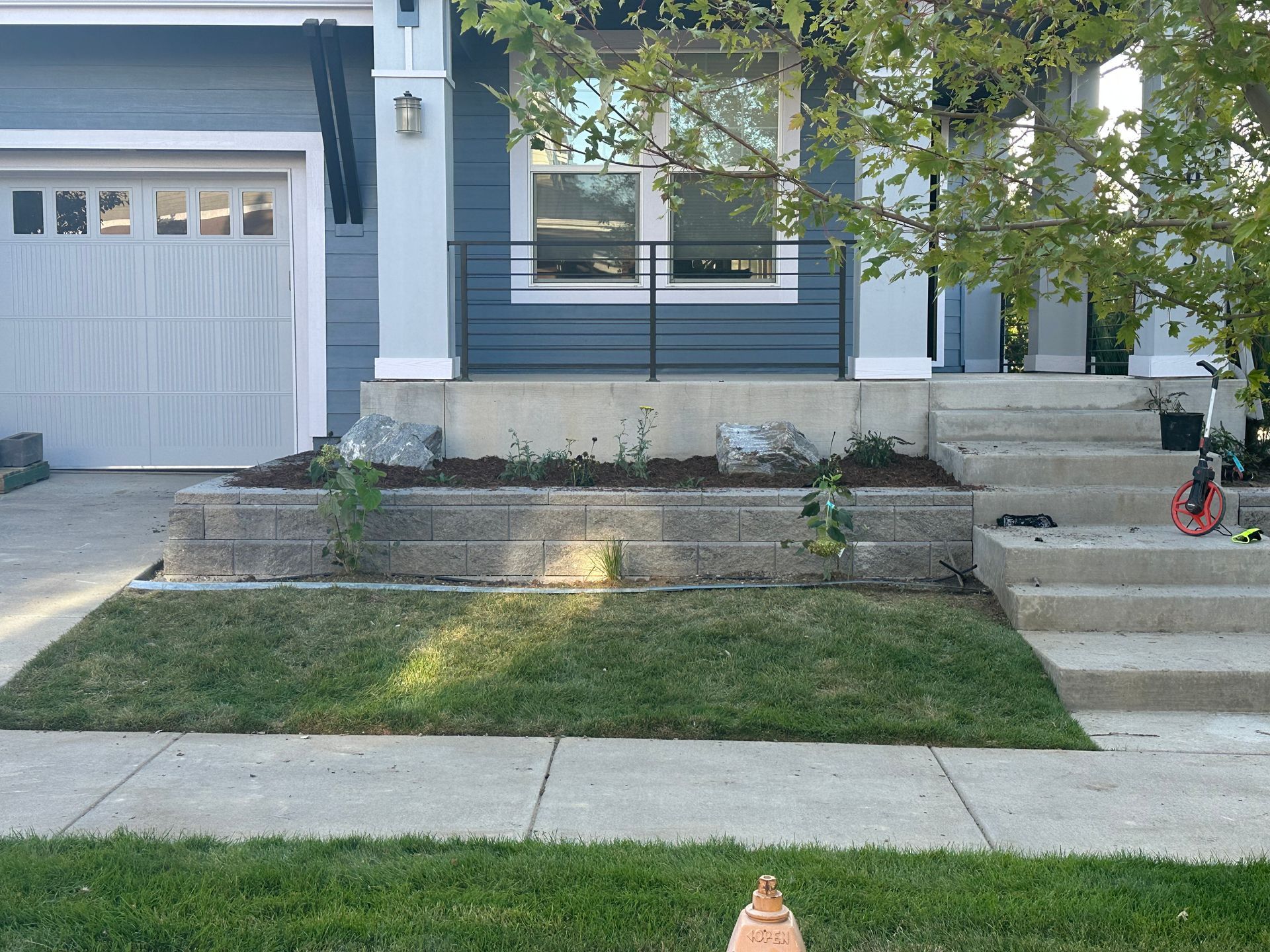 A blue house with a white garage door and steps