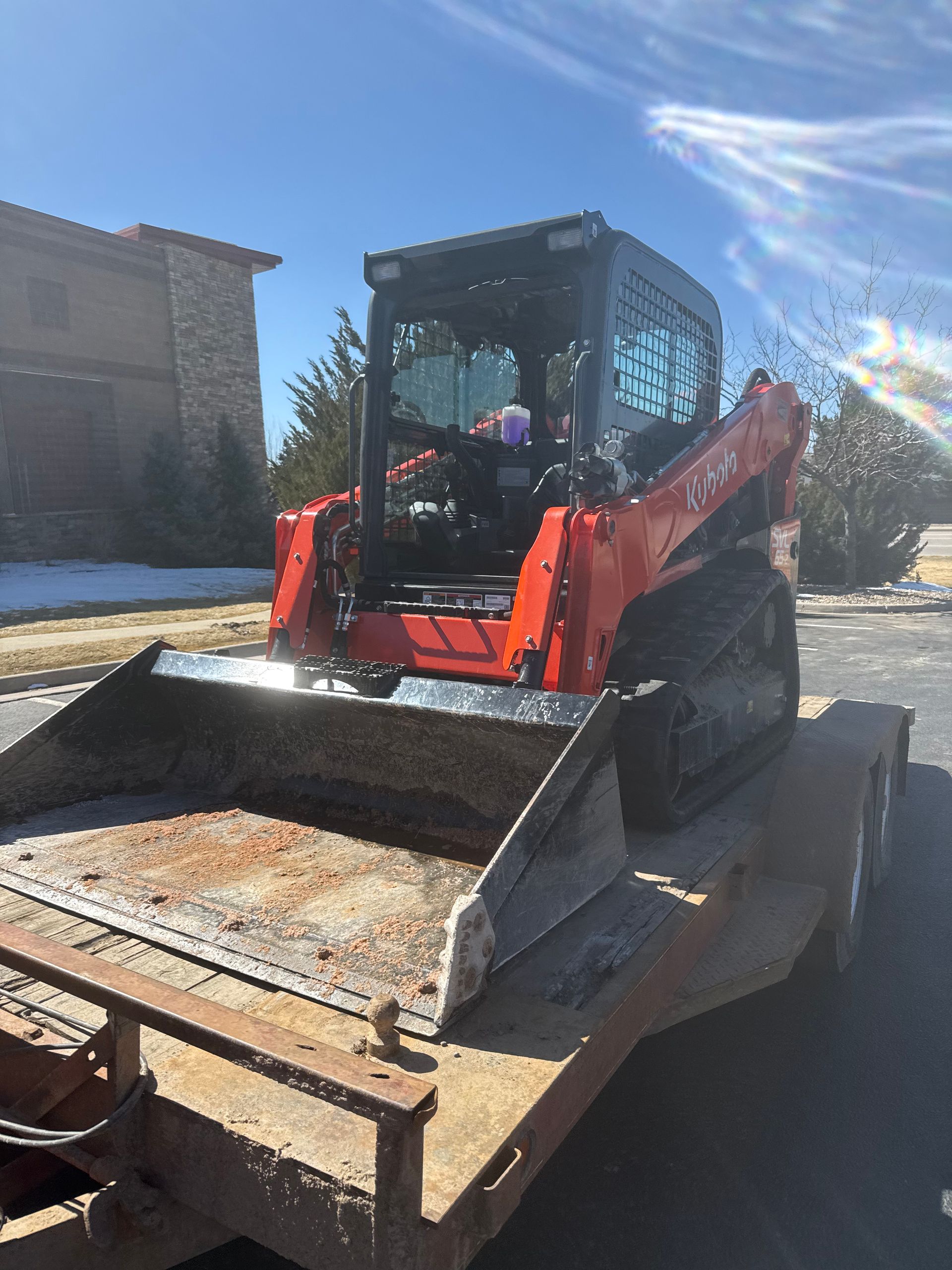 A bulldozer is sitting on top of a trailer.