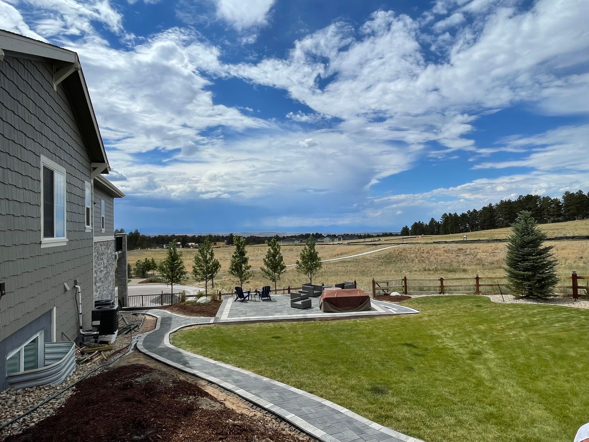 A house with a large lawn in front of it.