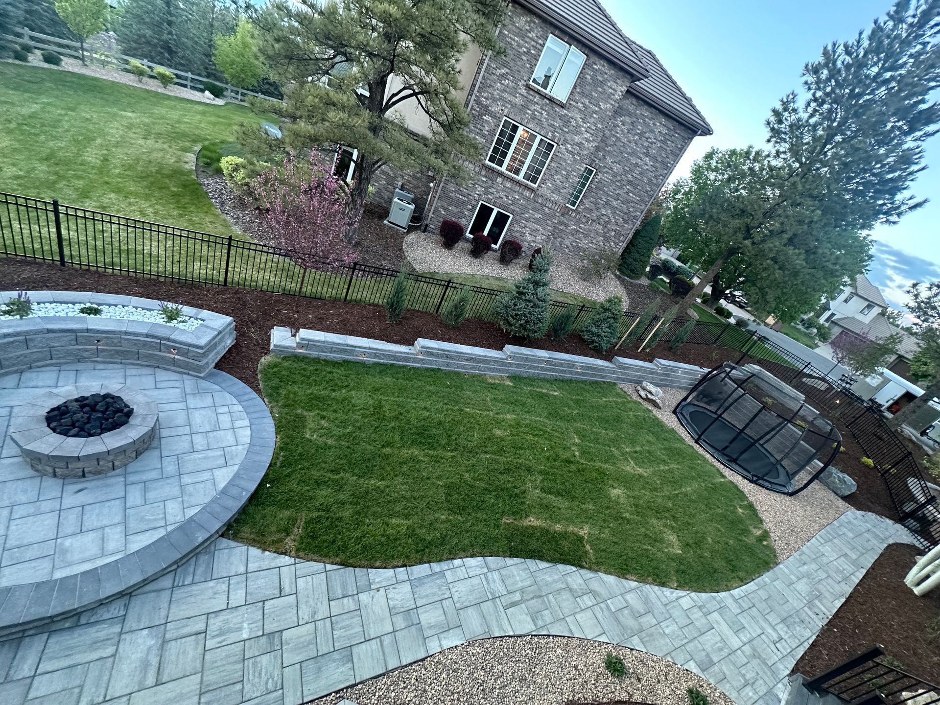 There is a fire pit in the middle of the backyard.