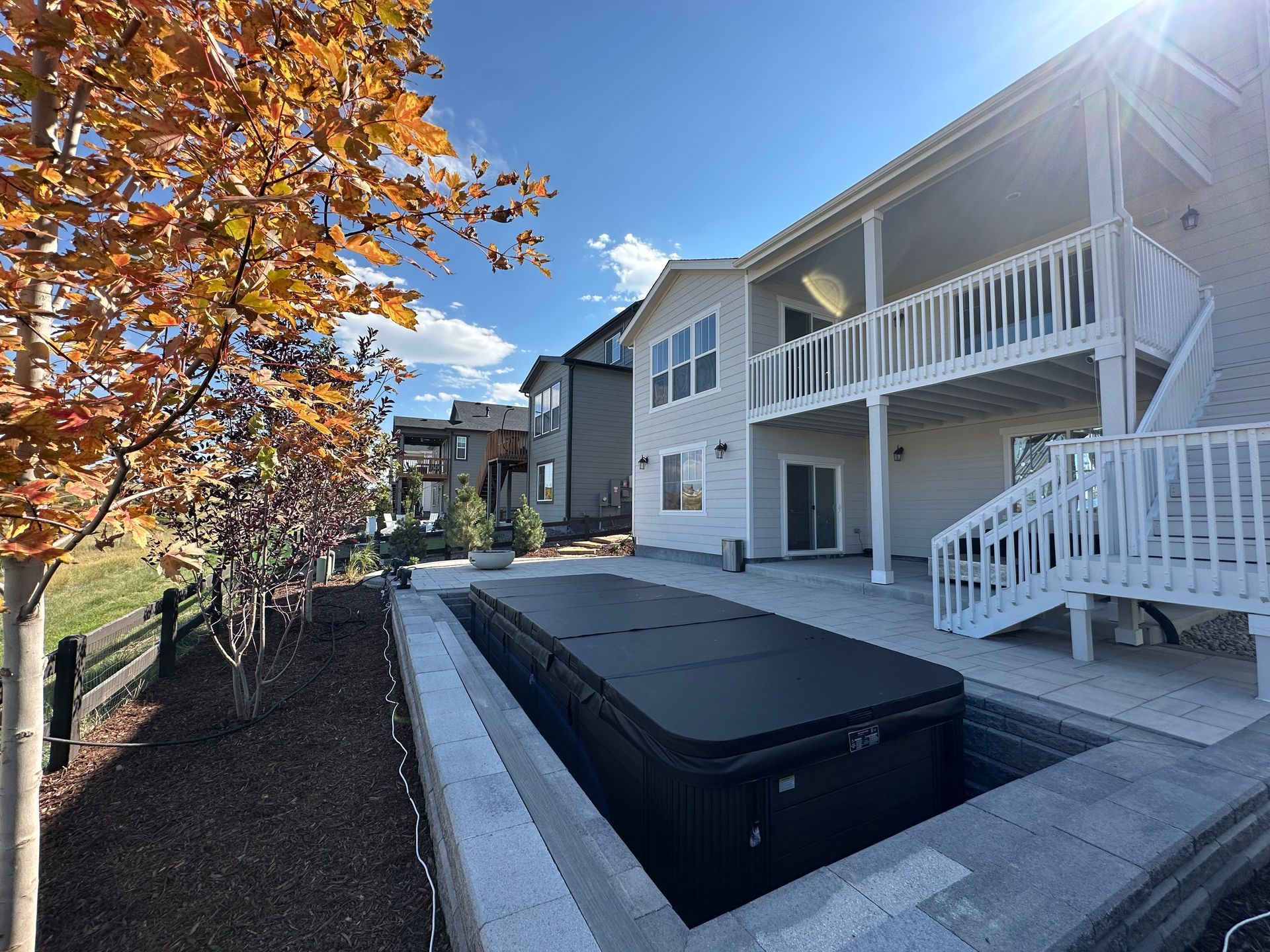 A large house with a hot tub in the backyard.