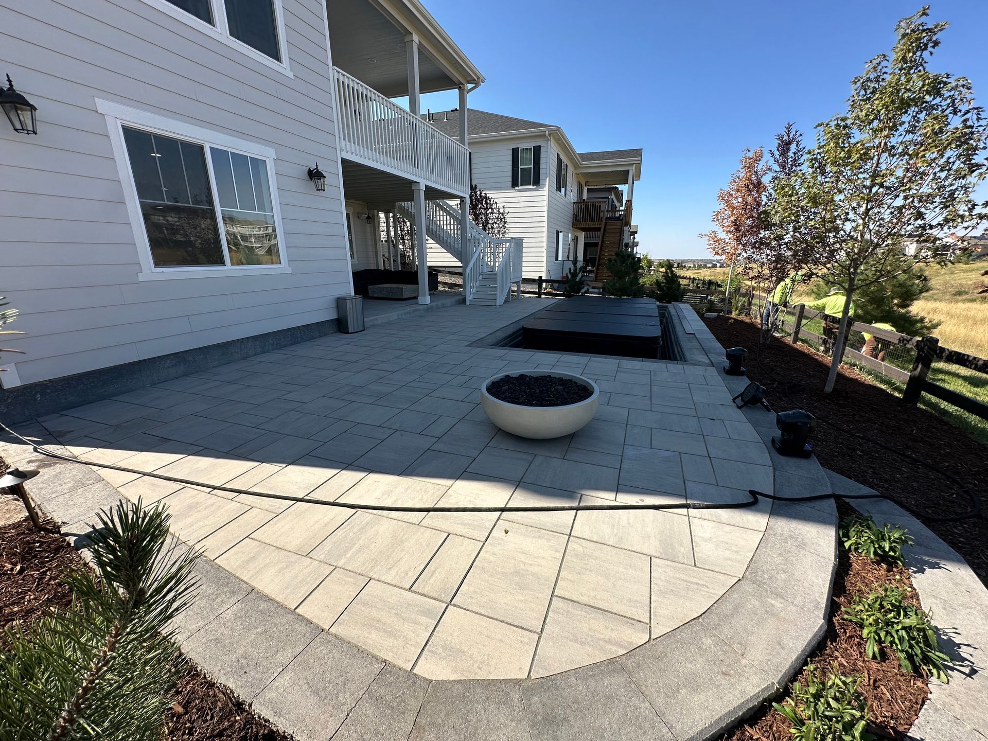 A large white house with a patio and a fire pit