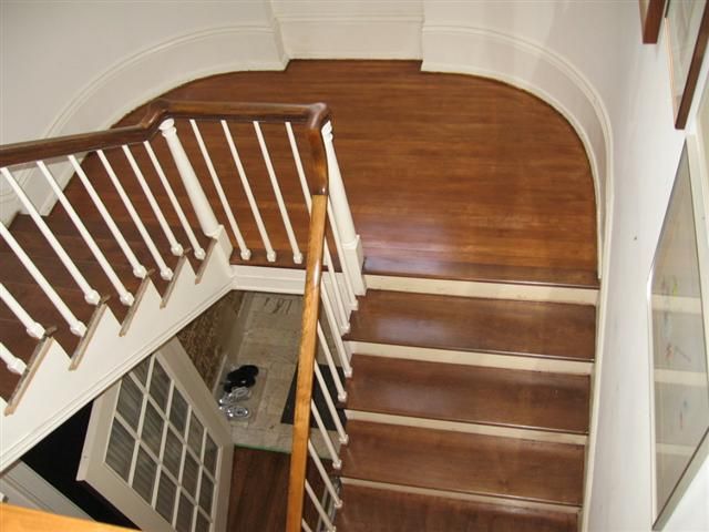 A staircase with wooden steps and white railings