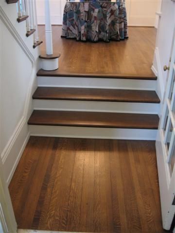 A staircase with wooden steps and a table in the background.