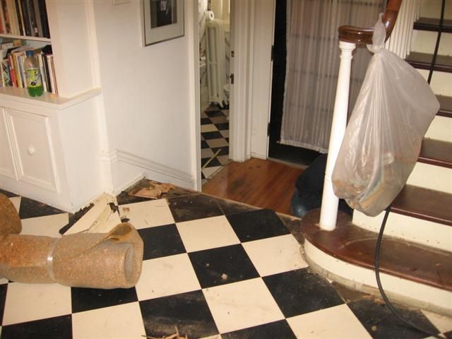 A black and white checkered floor next to stairs.