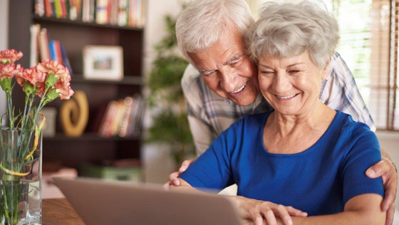 Image of Elderly Couple Looking At Laptop Screen