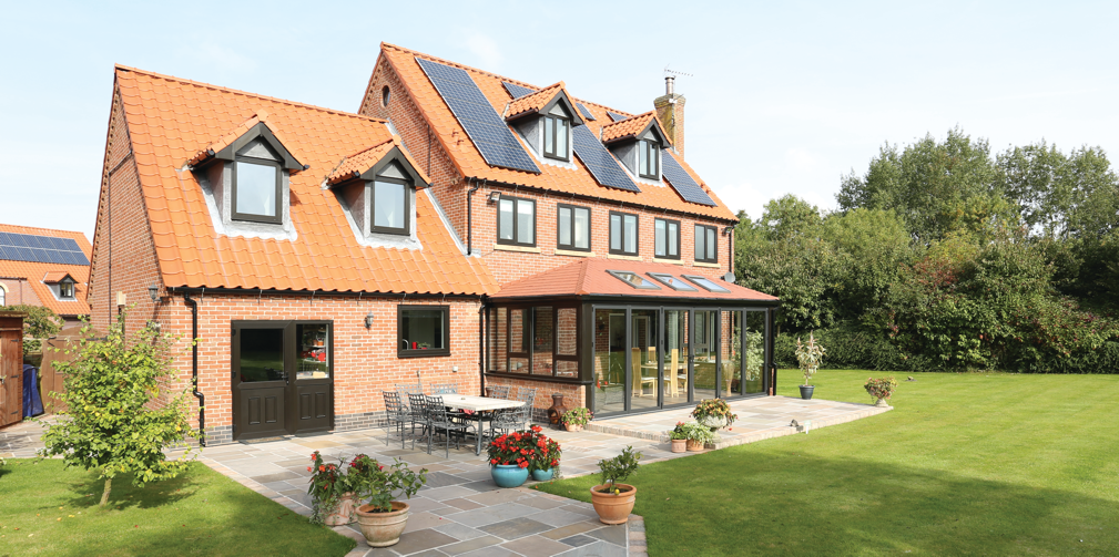 A large brick house with solar panels on the roof