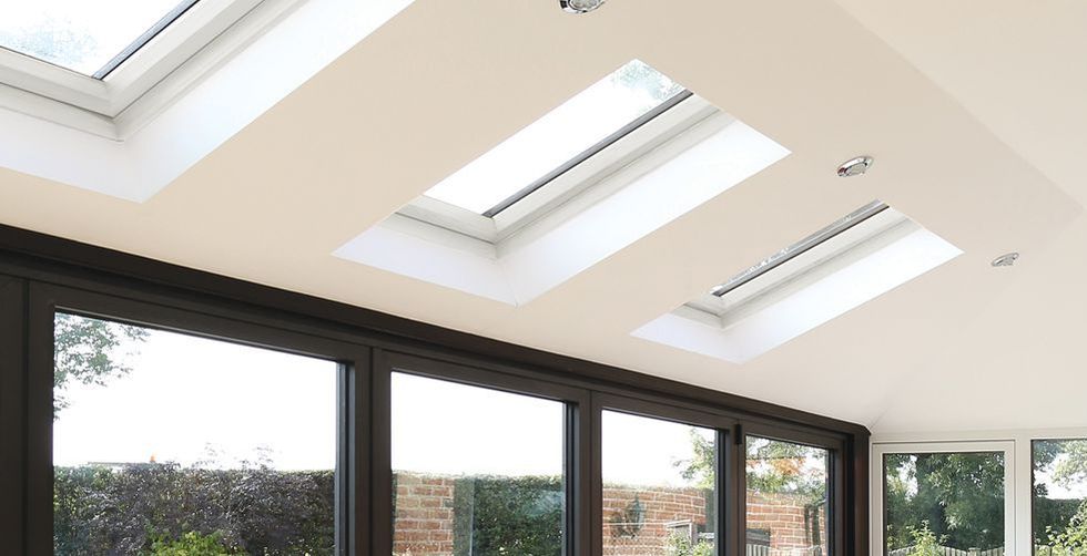 A room with a lot of windows and skylights on the ceiling.