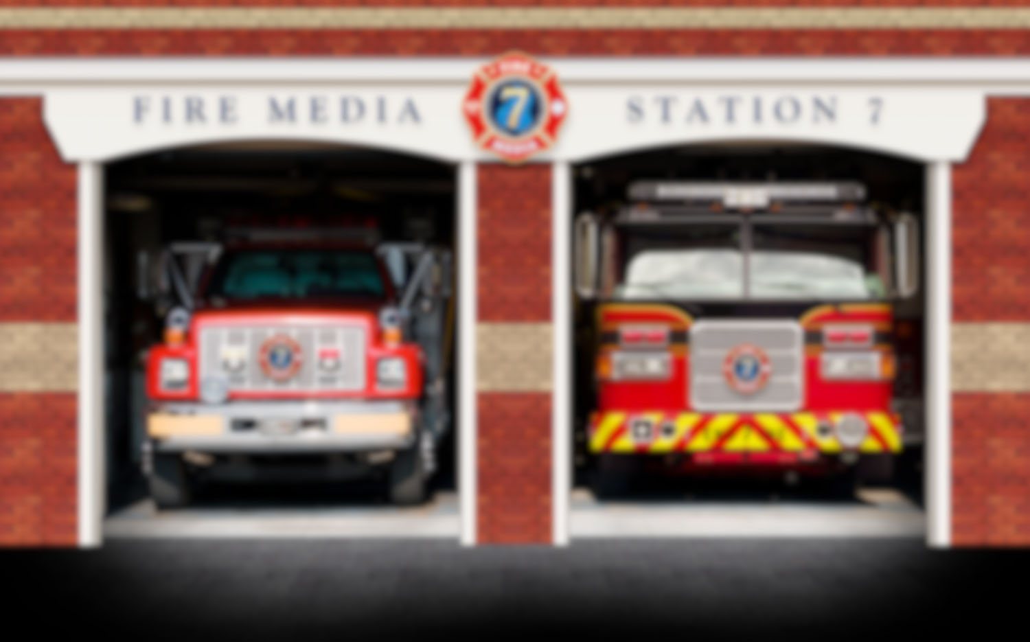 Two fire trucks are parked in front of a fire station