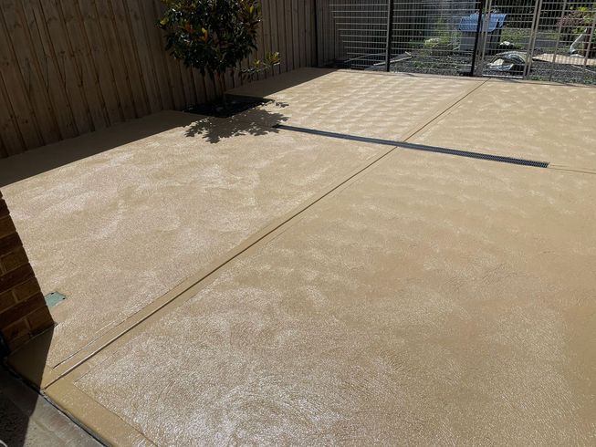 Coloured concrete driveway in Melton VIC adding a touch of personality to outdoor spaces.