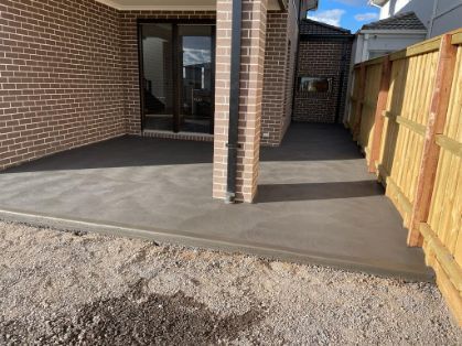 Expert concreters in Gisborne VIC working on a concrete flooring in a residential concreting project.