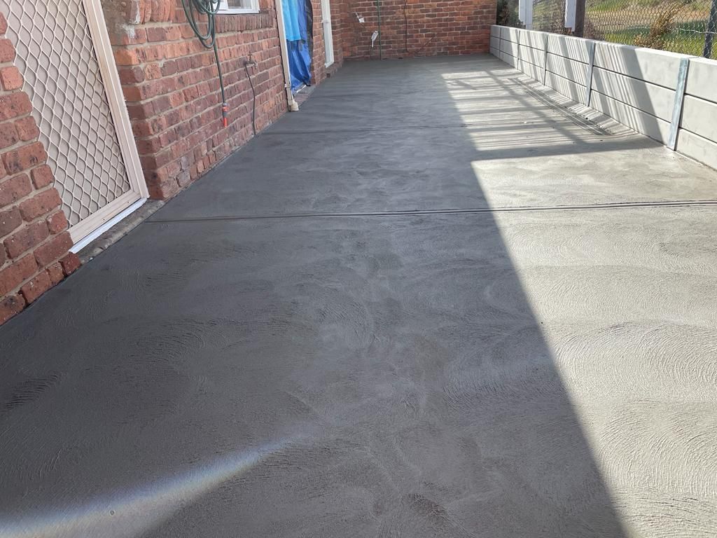 A residential backyard featuring expertly laid concrete in Melton VIC.