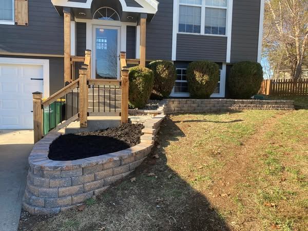 A house with a brick wall in front of it
