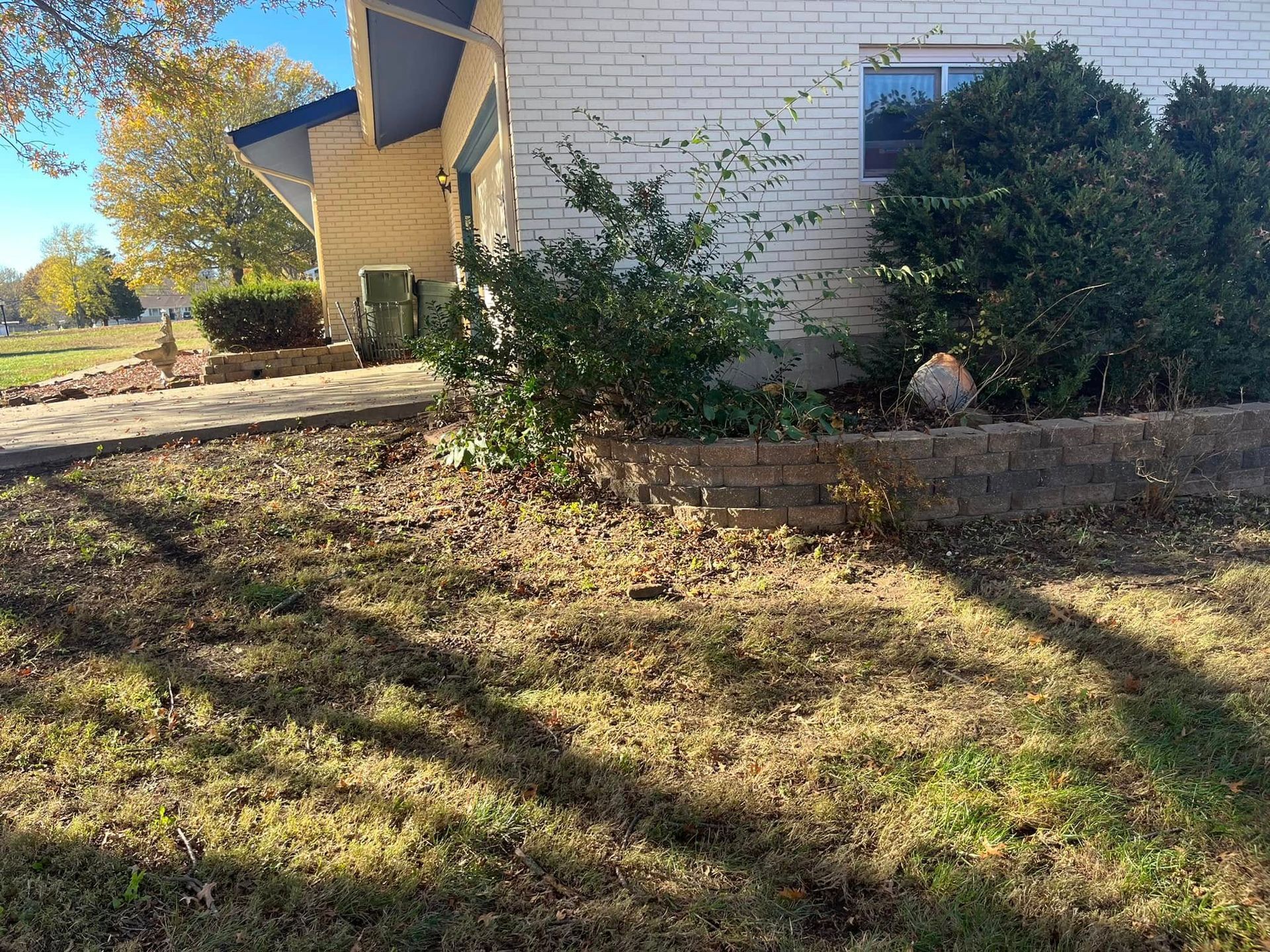 A white house with a lot of grass in front of it.