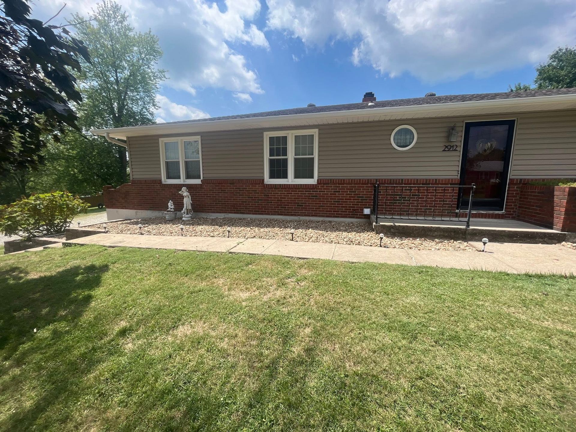 A brick wall is being built in front of a house.