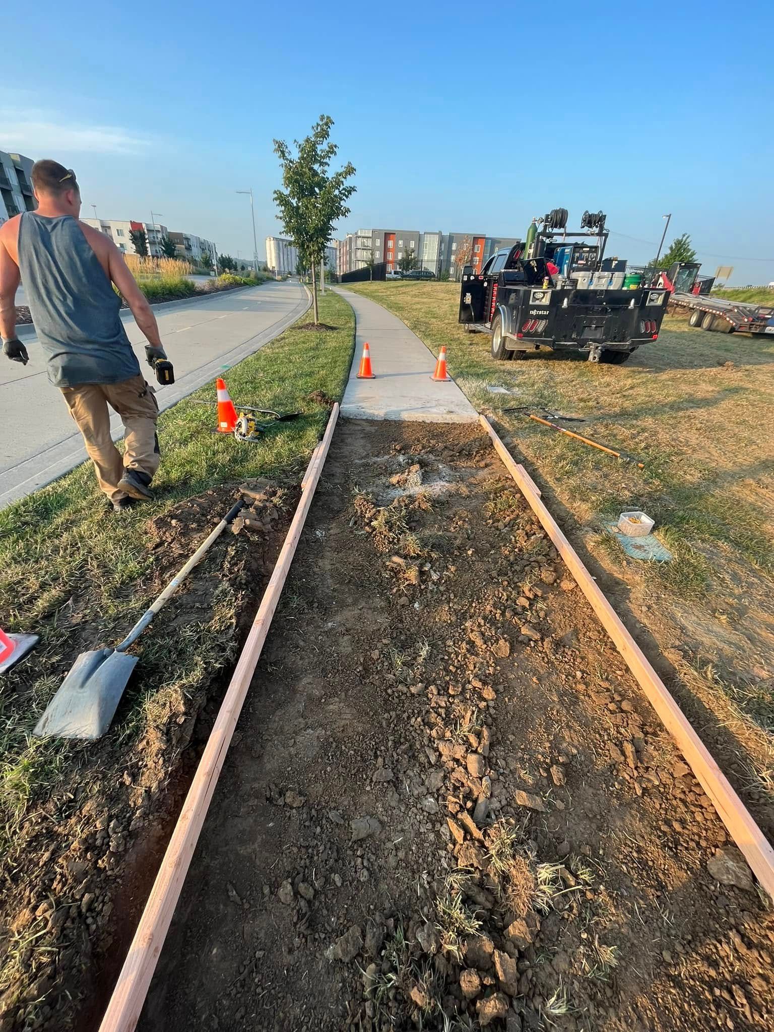 A man is digging a hole in the ground with a shovel.